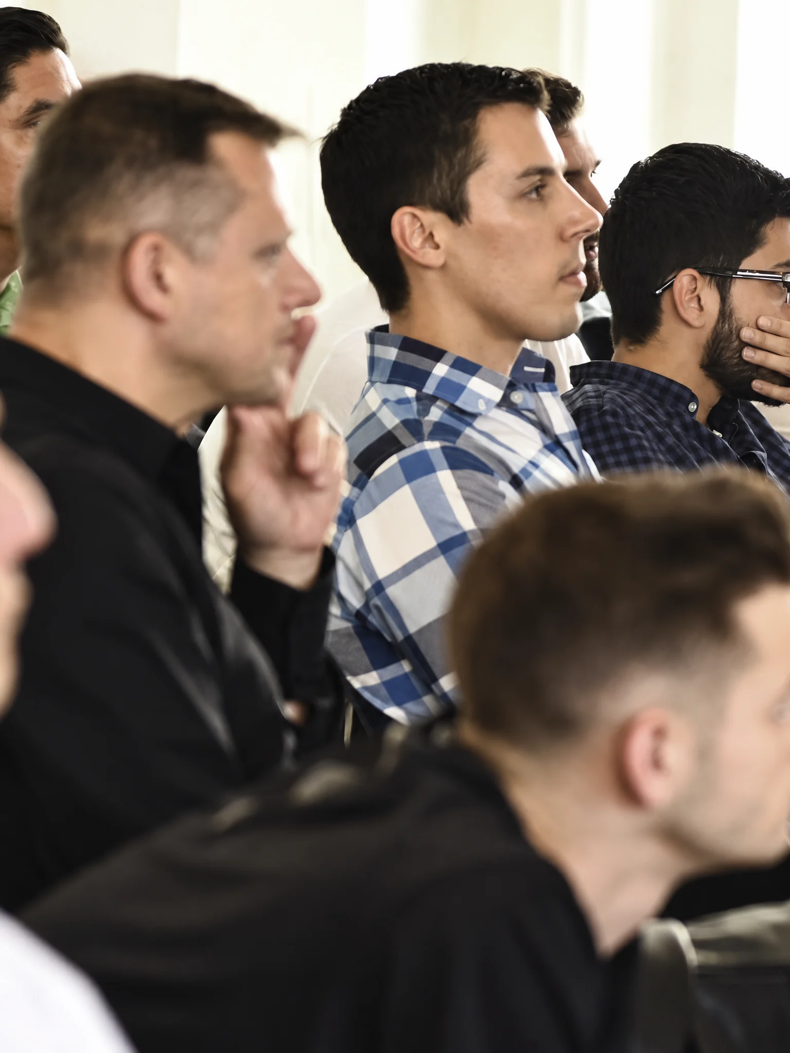 Audience members listening attentively to a presentation